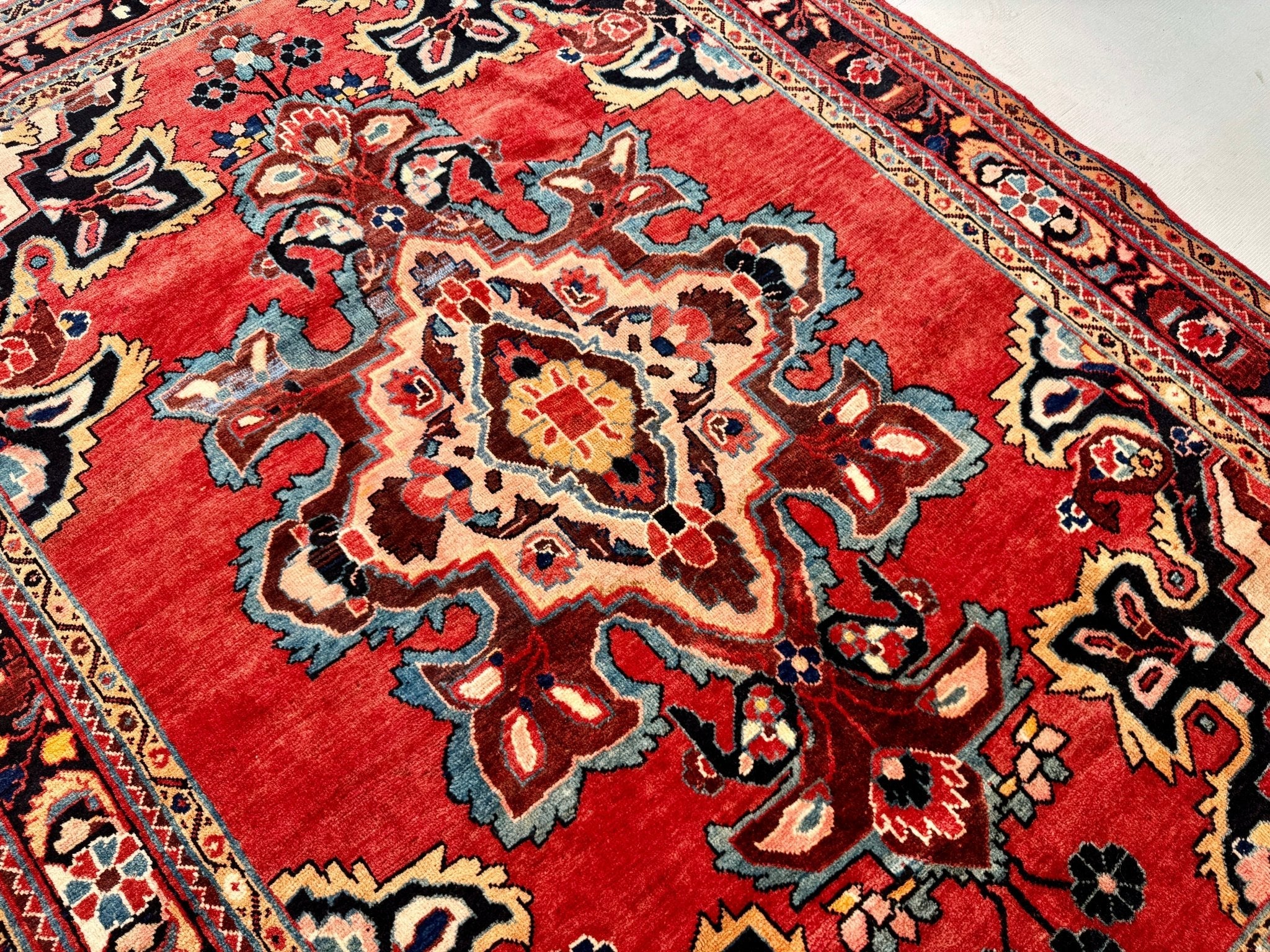 Persian Mahal area rug with red background and cream, teal, blue floral medallion shapes