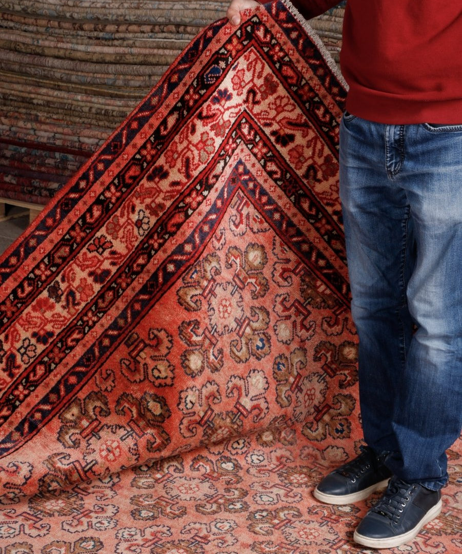 Persian Mahal rug corner on display with rust-red, cream, and navy geometric details