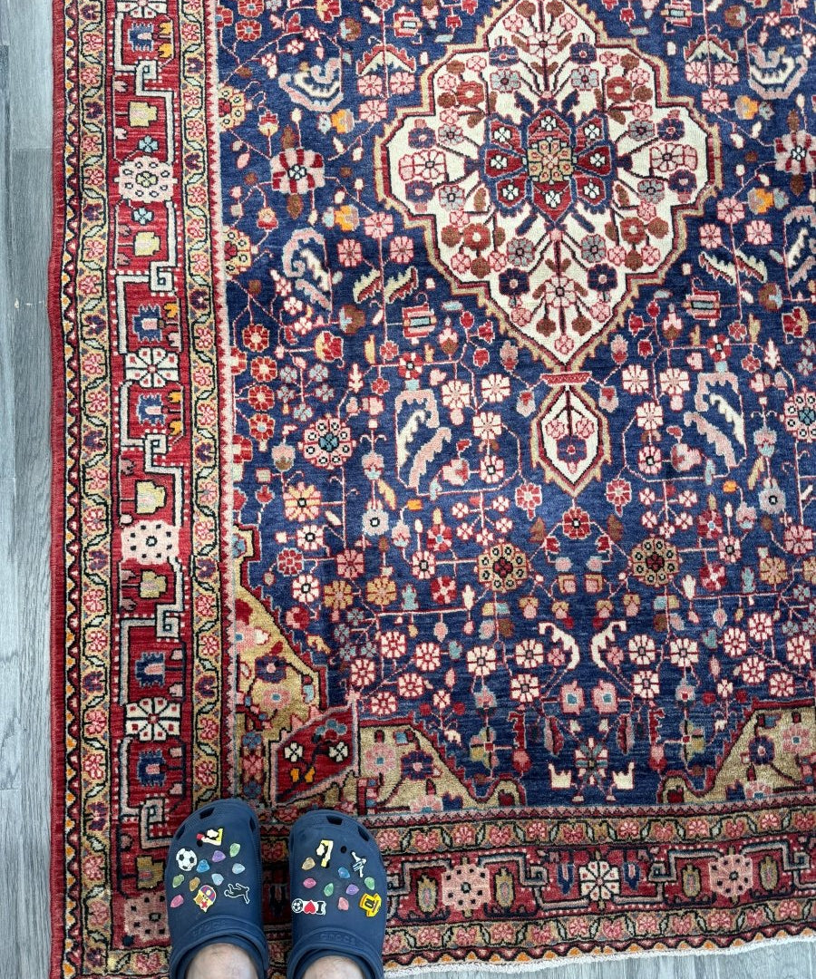 Persian Malayer rug with navy blue field, cream medallion, and red floral border details