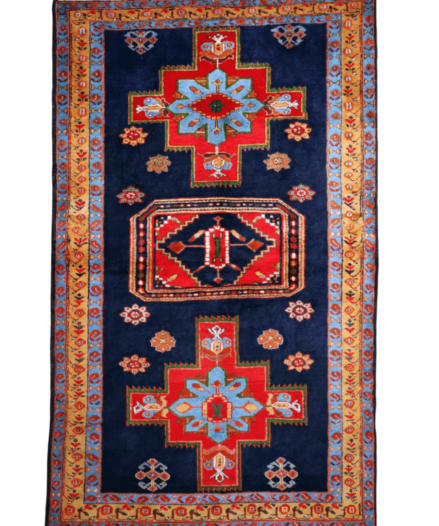 Persian Meshkin rug, full view with navy field, red central cross, multicolor border