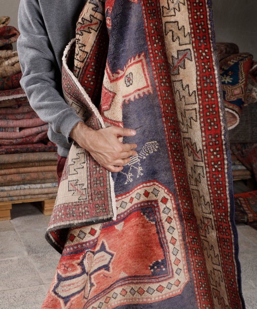 Runner rug shown folded; navy, red, and cream geometric patterns with repeating borders.