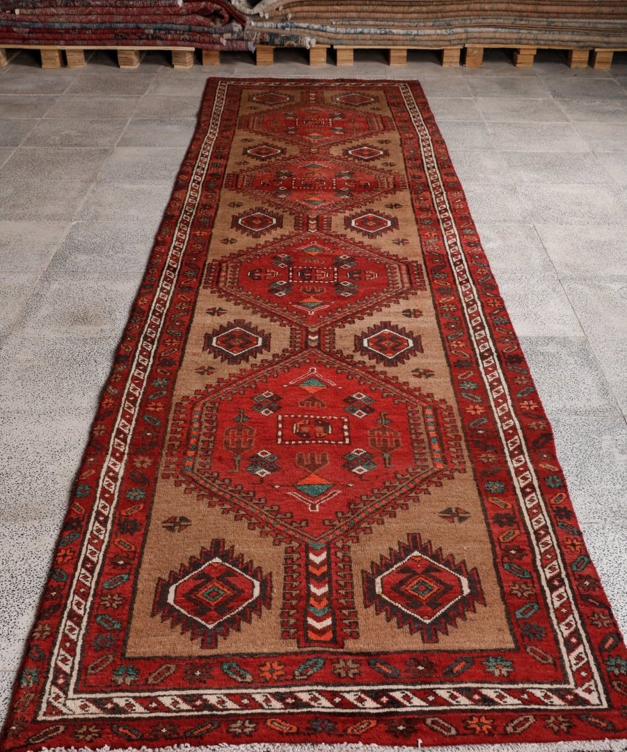 Persian runner rug, red and beige with central medallion, bordered geometric pattern