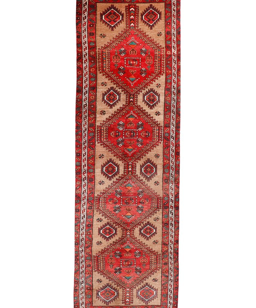Persian runner rug with red medallion and geometric diamond motifs, beige ground