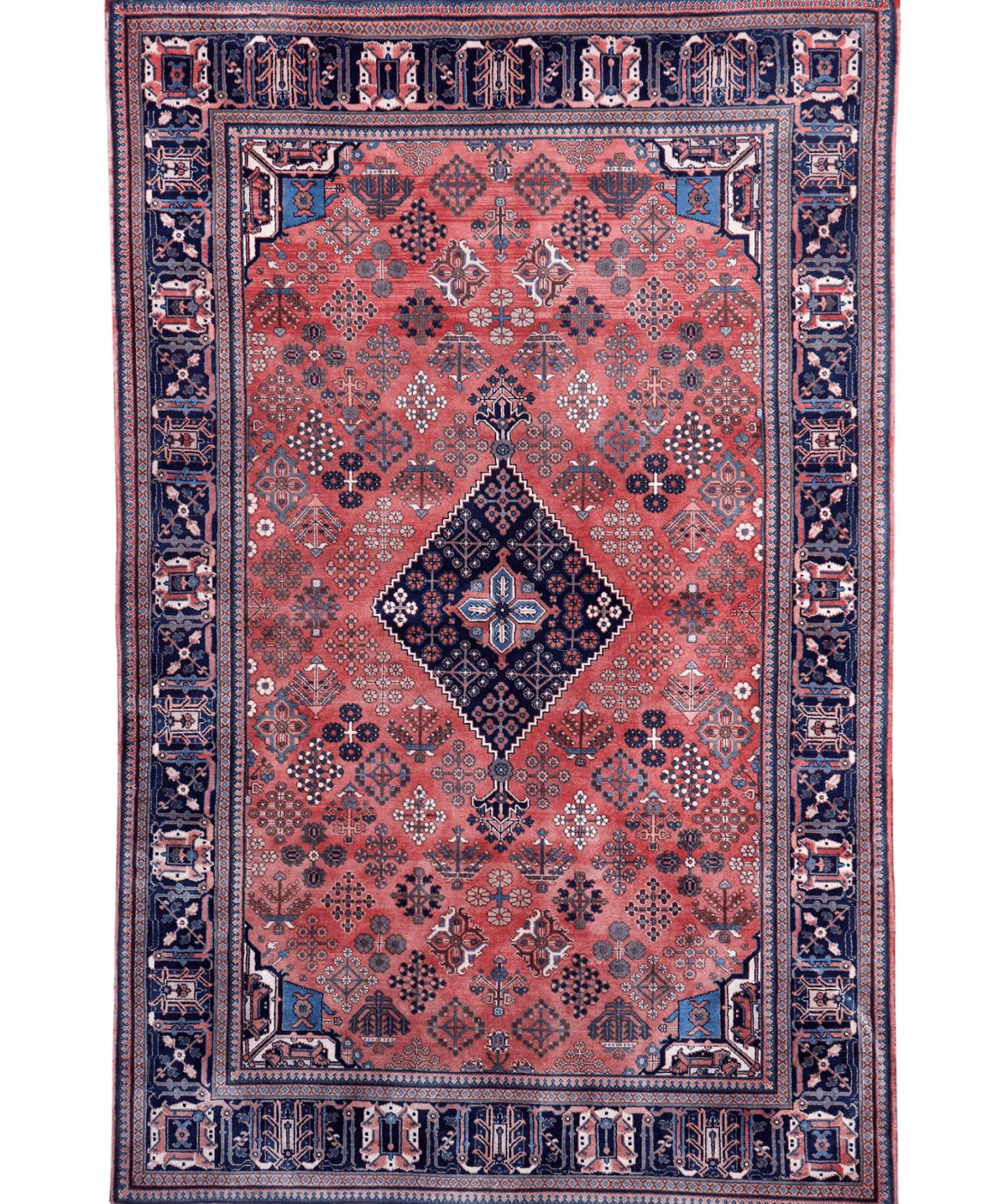 Rust and navy Persian-style area rug with central diamond medallion, ornate frame, fringe