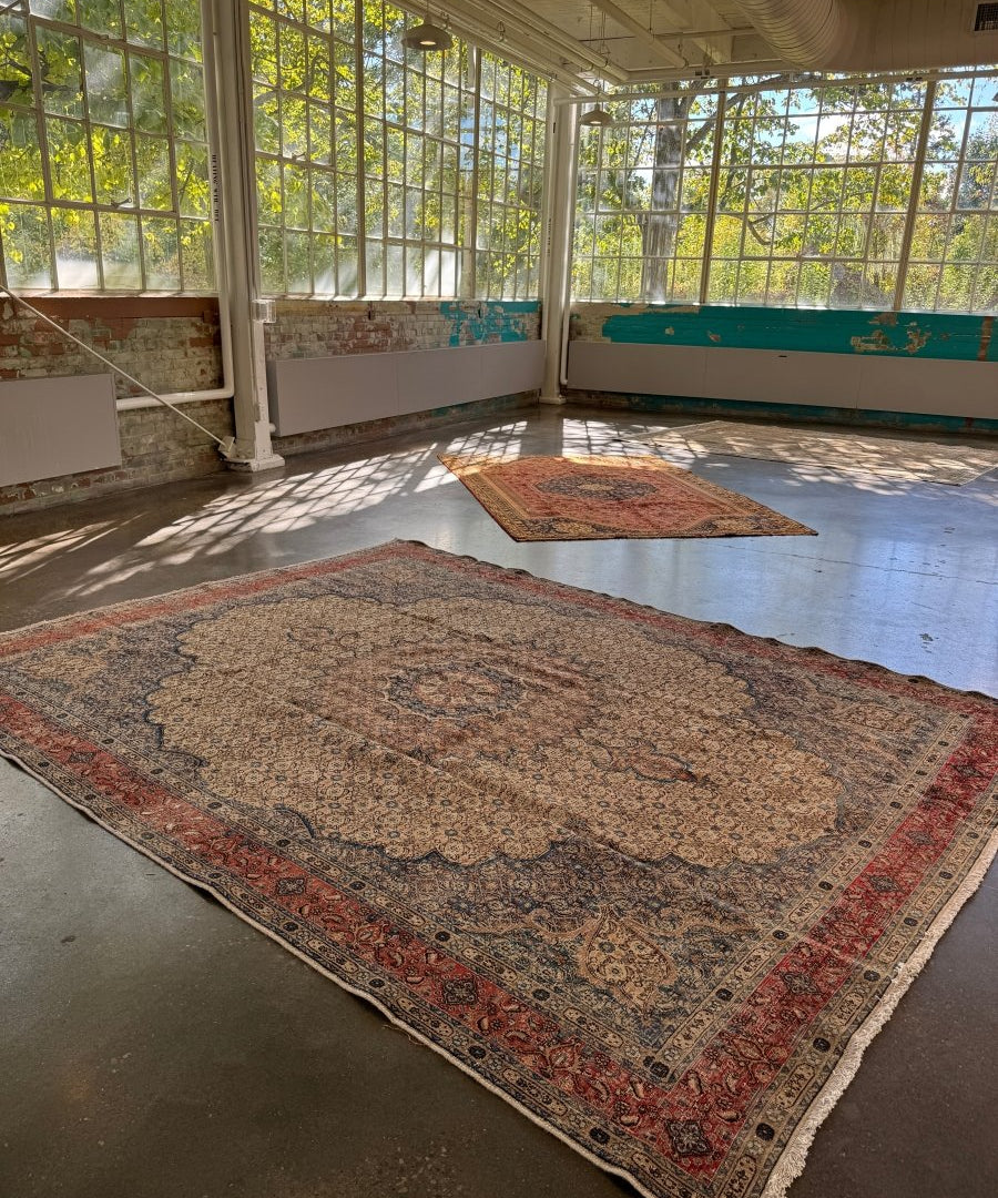 Persian-style rug laid flat with blue, beige, and red ornate pattern