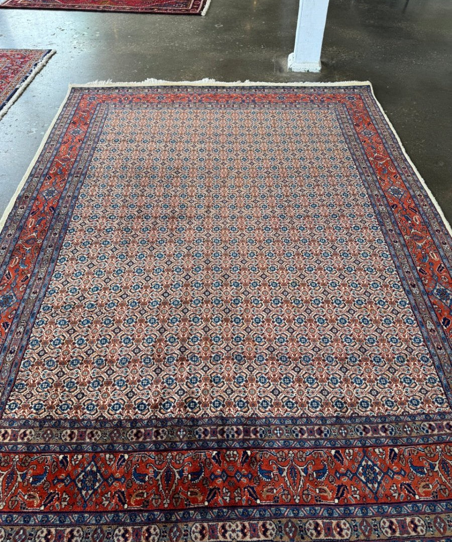 Persian-style rug with light blue center medallions and red-and-blue border