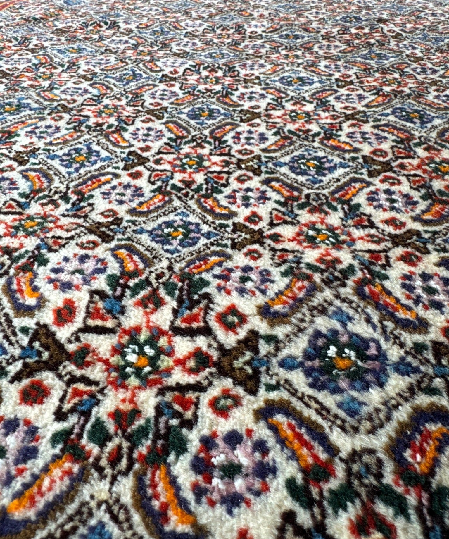 Persian Moud rug with multicolor floral medallion pattern on light ivory base.