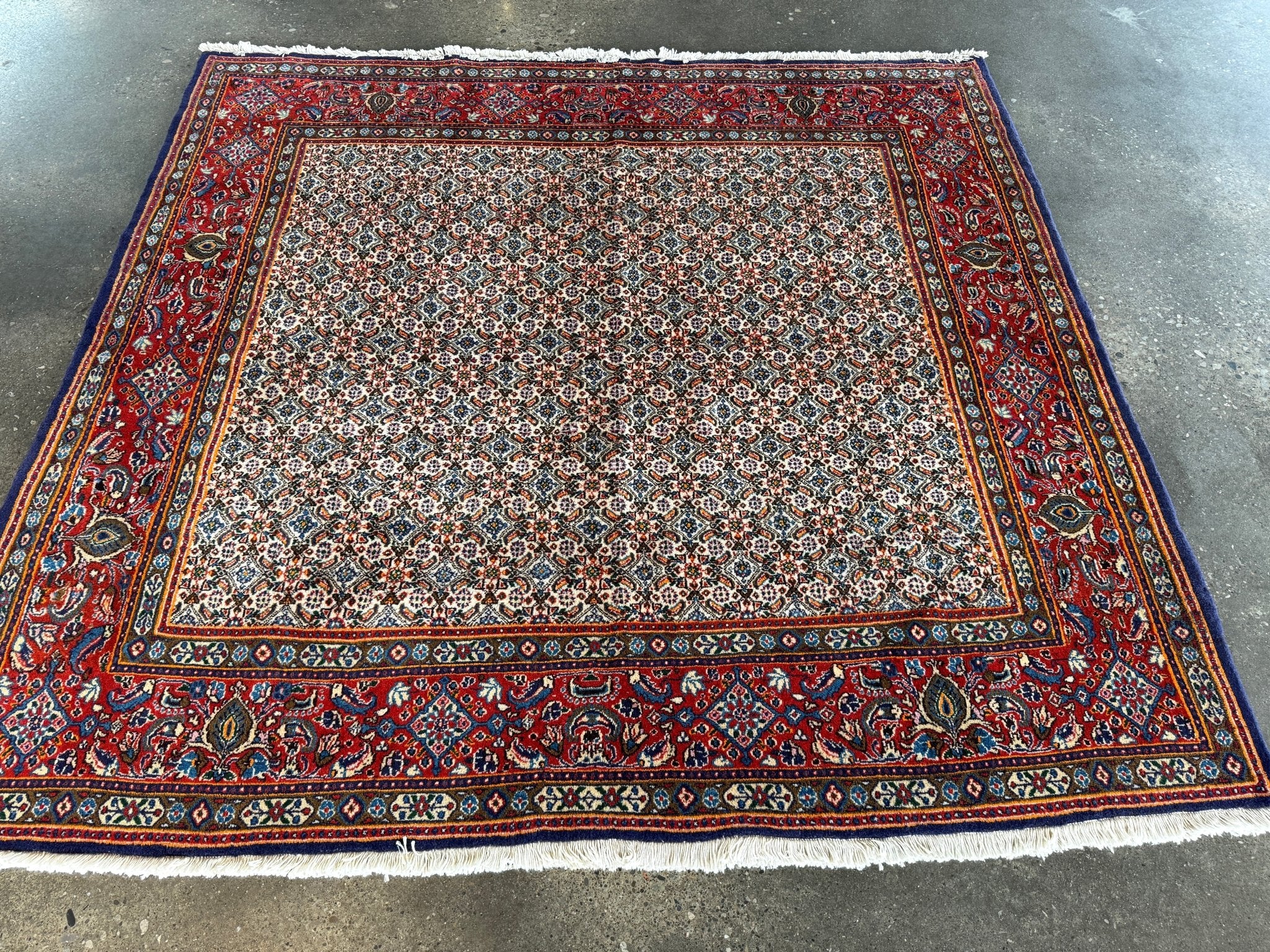 Persian Moud rug flat view with red frame and cream center of small repeating motifs.