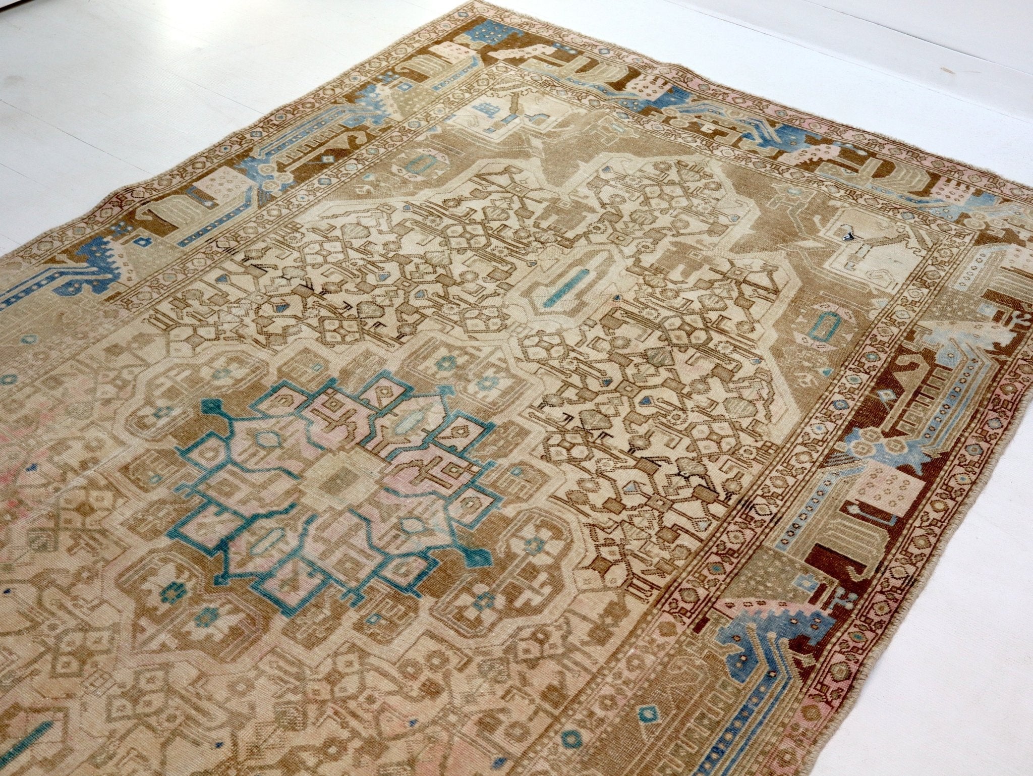 Persian Nahavand rug with beige medallion and teal border, ornate geometric pattern
