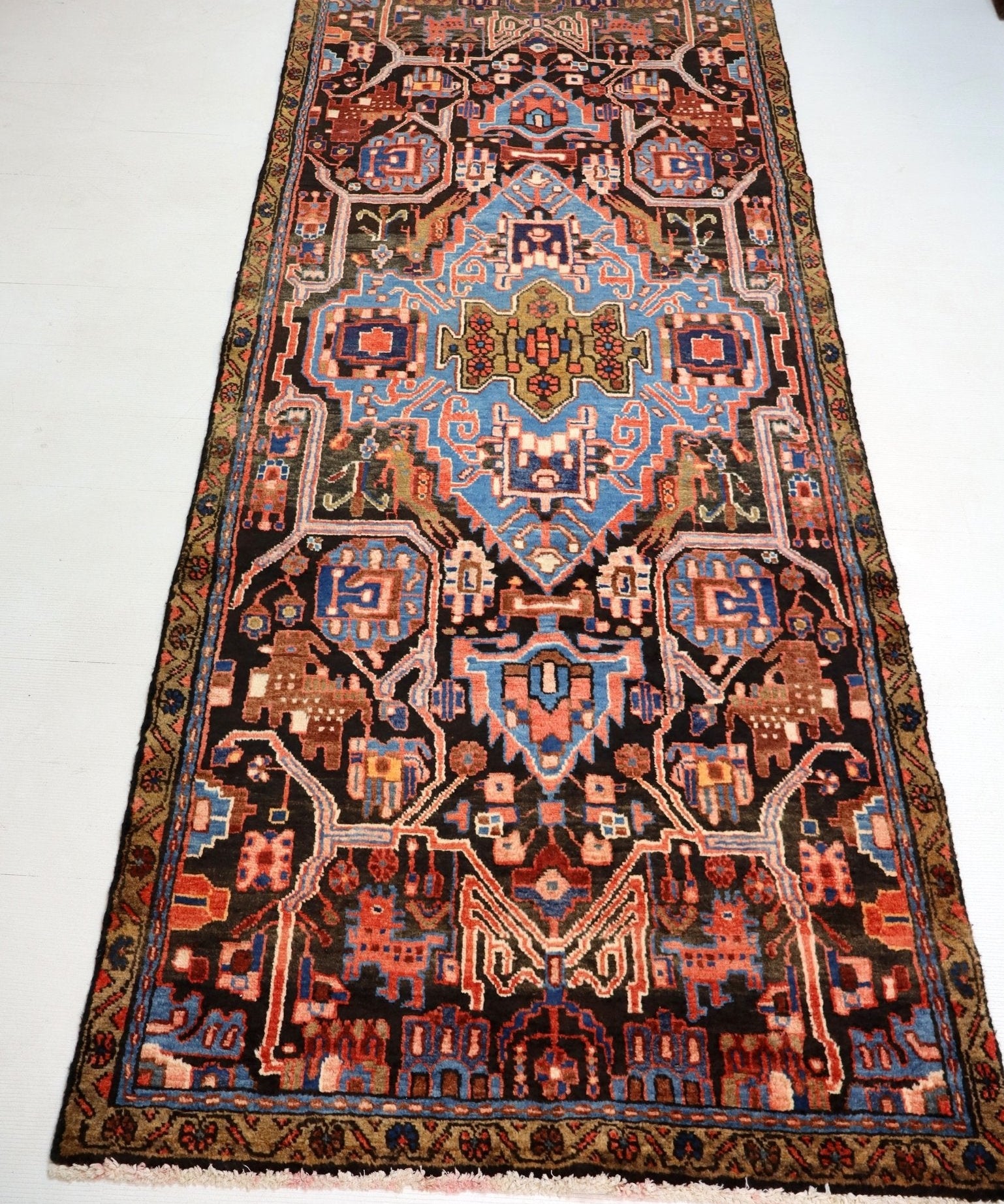 Persian runner rug full view with central medallion and detailed border in rust and blue