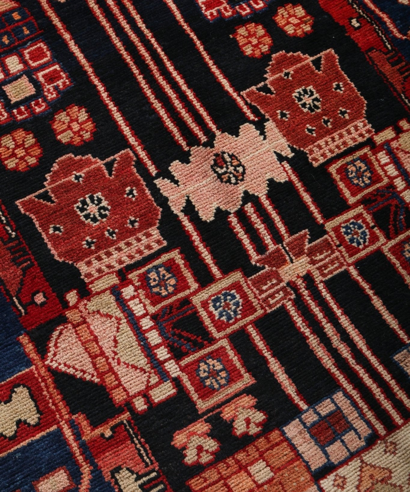 Persian runner rug close-up of navy ground with red and cream diagonal stripes