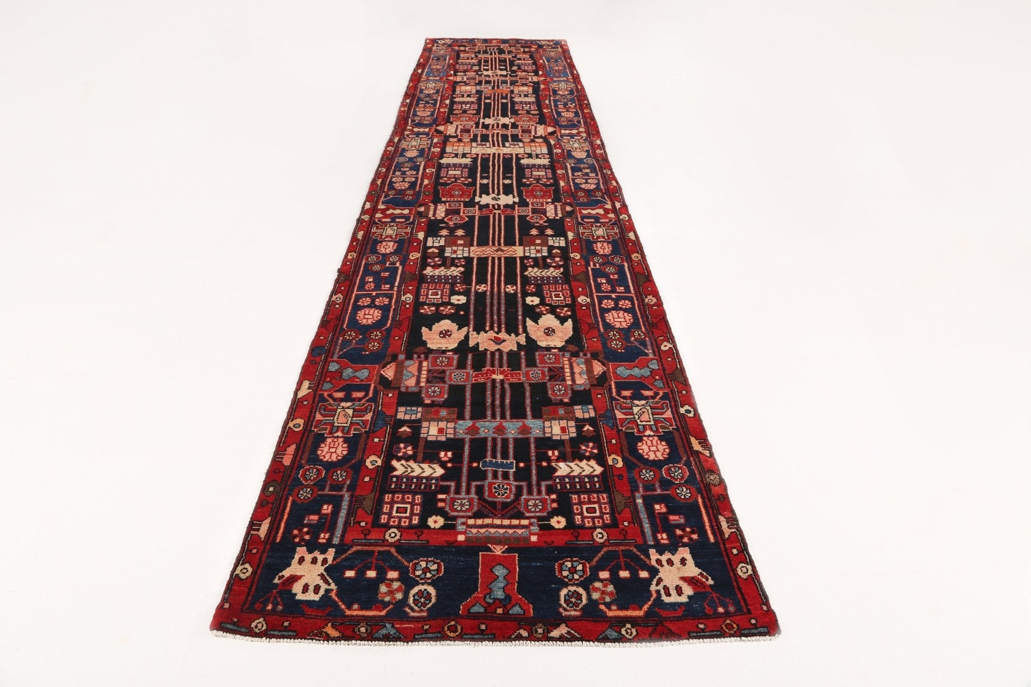 Persian runner rug with navy, red, and cream geometric medallions