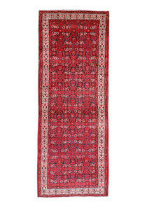 Persian runner rug studio view with dark red central motif, cream frame, and thin fringe.