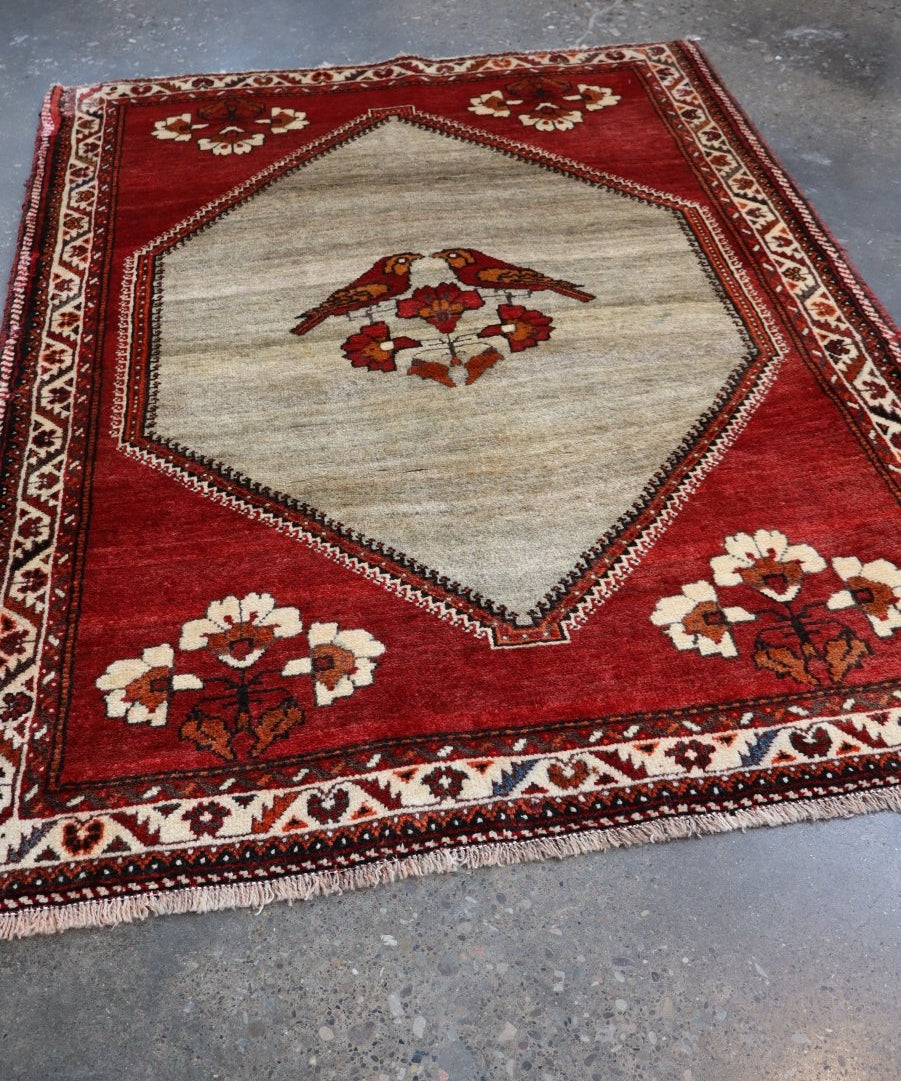 Persian Qashqai Gabbeh rug, red field with ivory diamond center and floral accents