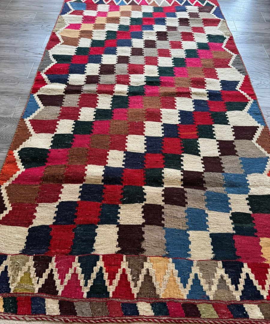 Persian Qashqai kilim rug with multicolor geometric blocks and zigzag border, flat-weave