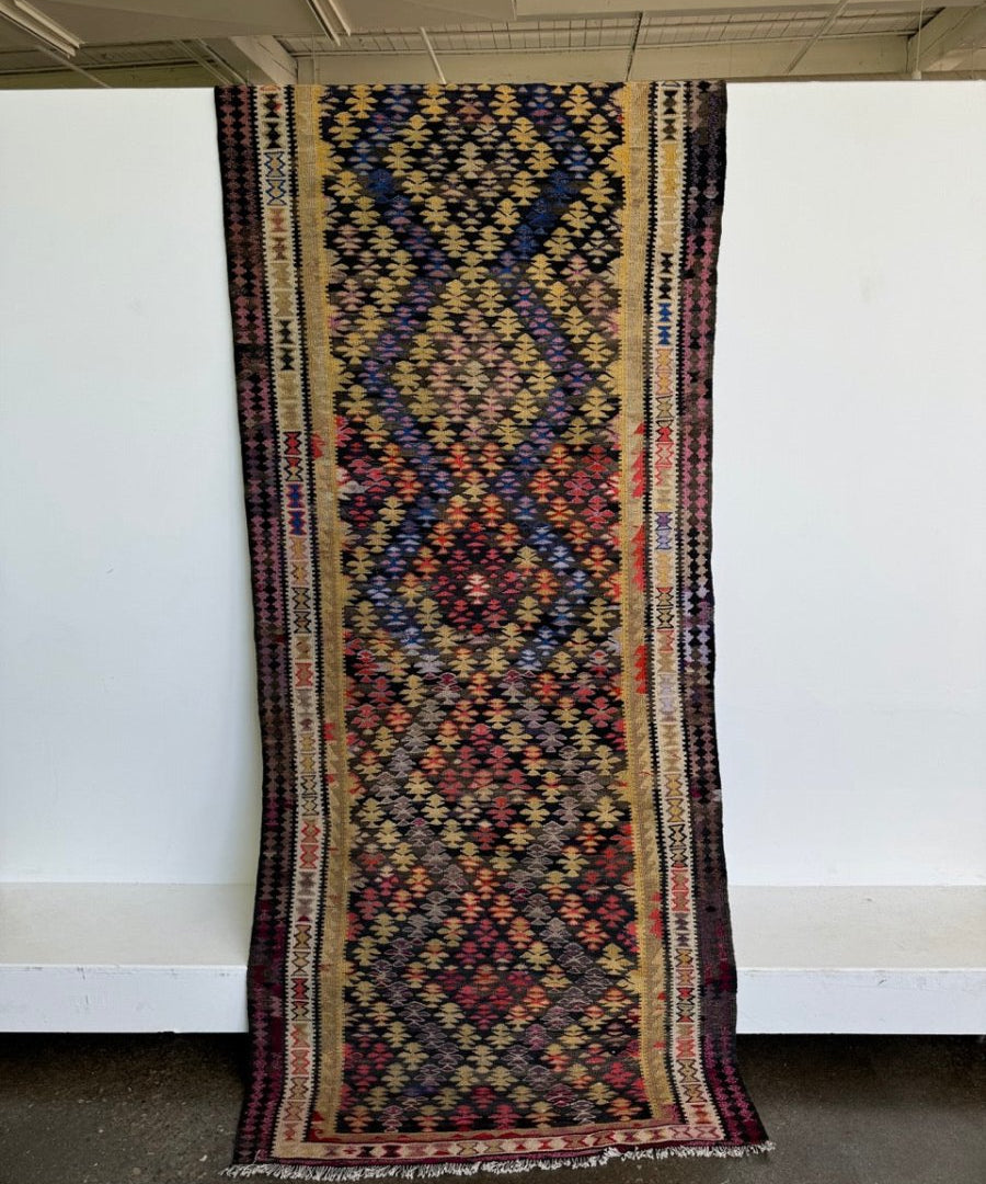 Kilim runner rug with navy, blue, red, and cream geometric medallion pattern