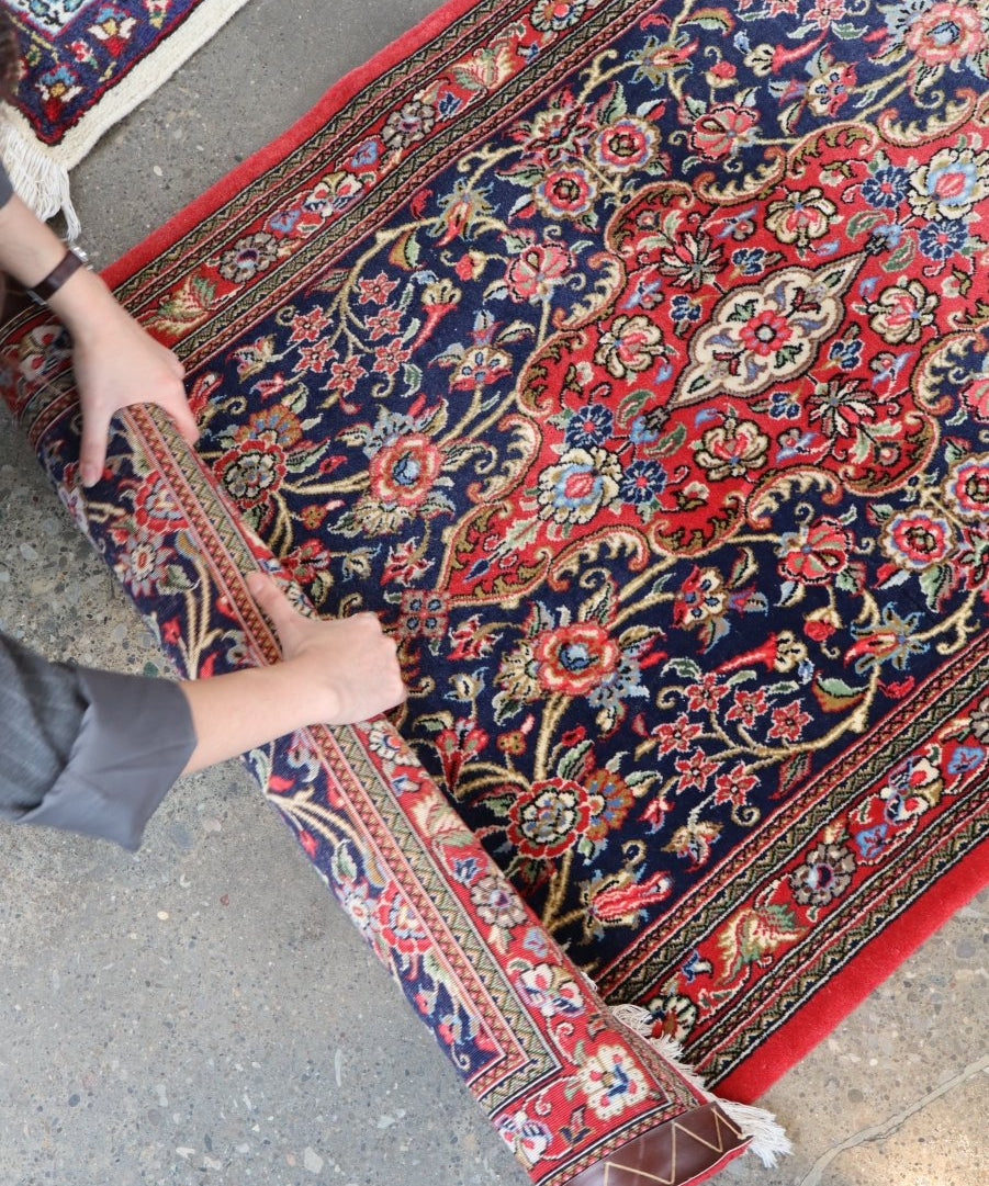 Persian Qom Kork wool runner rug folded edge with red border and navy floral pattern