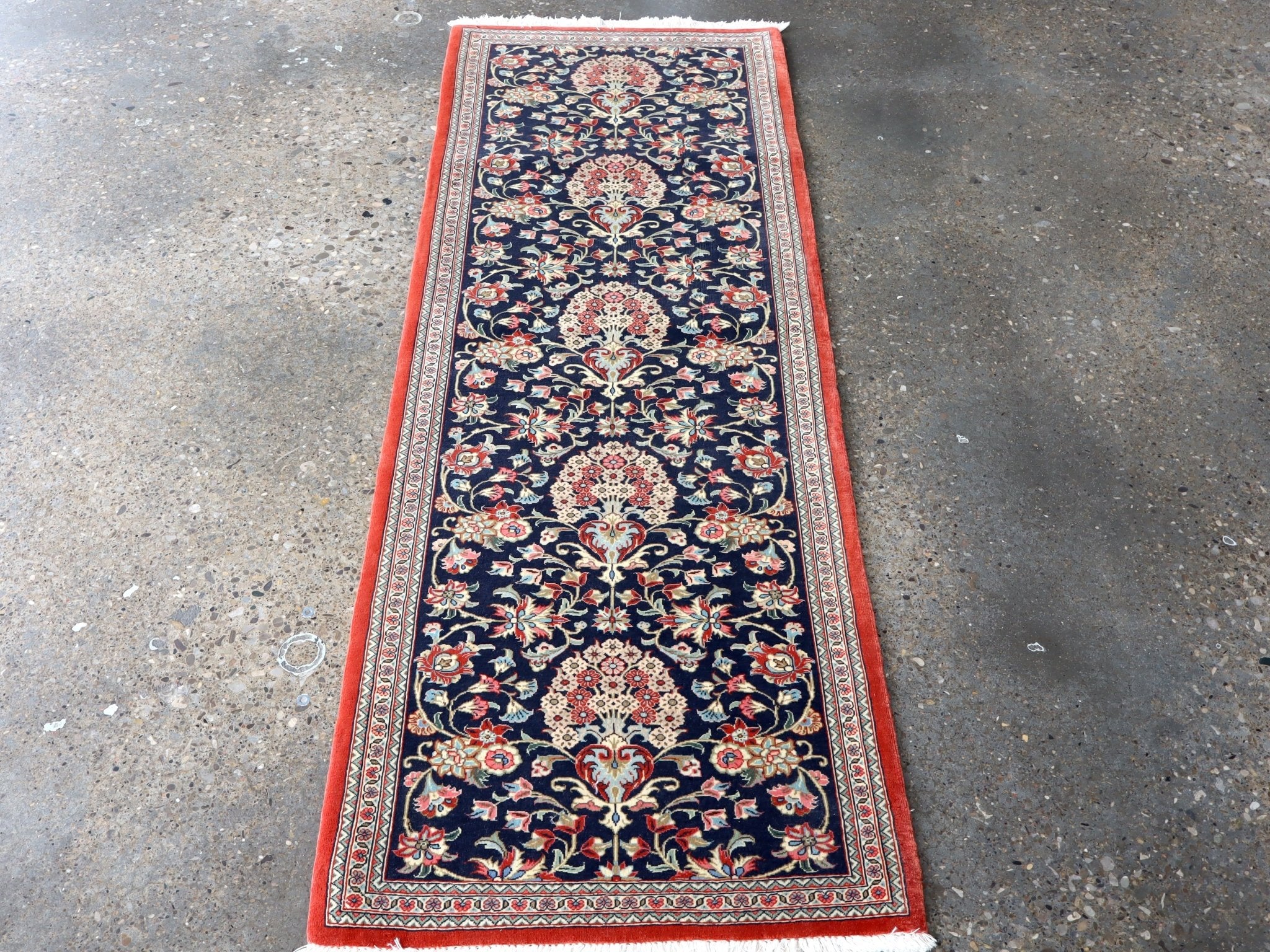 Persian Qom runner rug, navy with central medallion, floral vines, red edge border