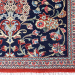 Persian Qom runner rug close-up of border: navy, cream and red floral panel