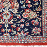 Persian Qom runner rug close-up of border: navy, cream and red floral panel