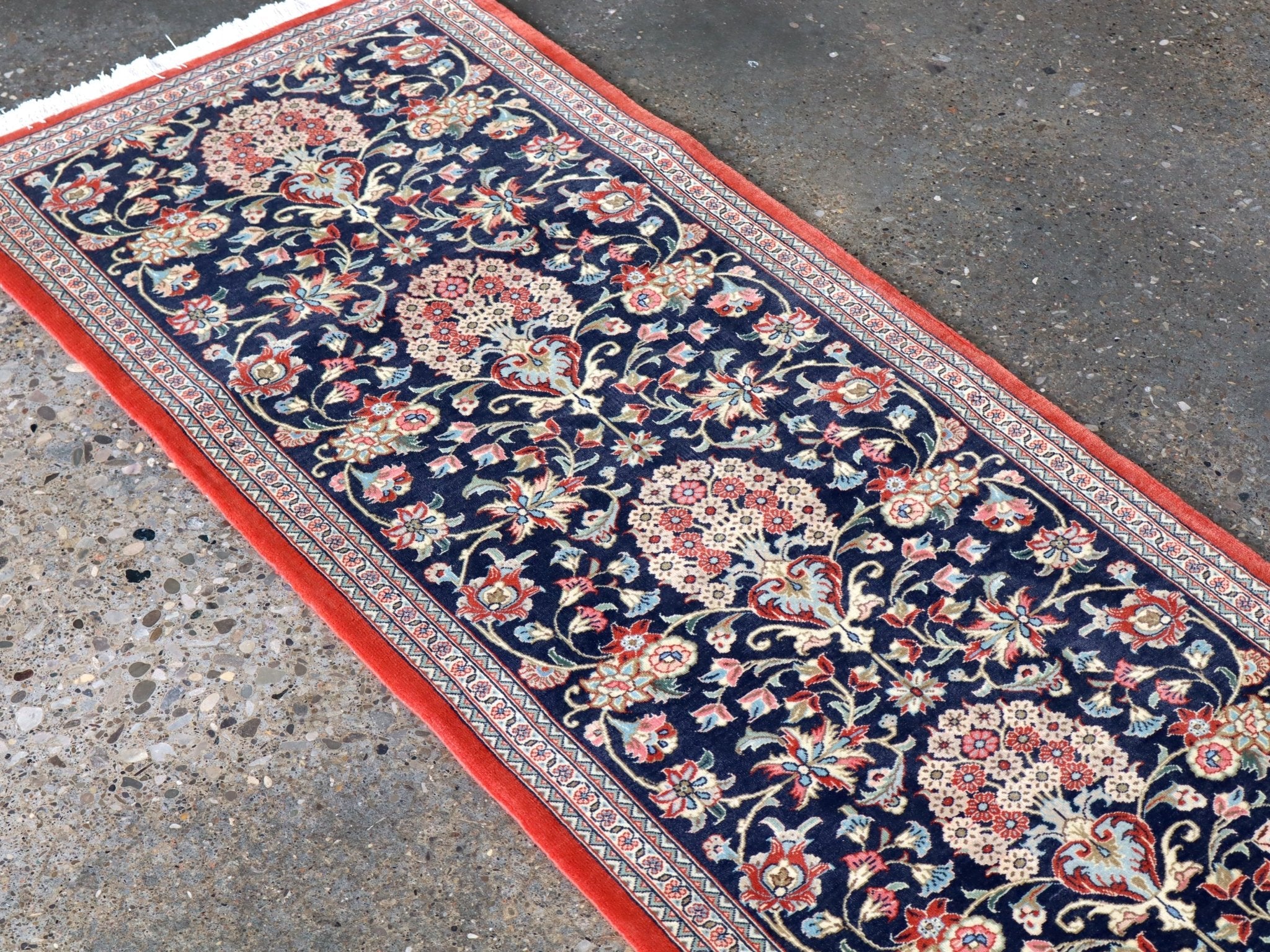Navy Persian runner rug with red border and floral medallion pattern