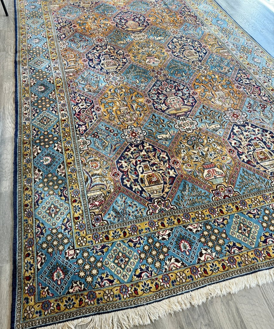 Persian Qum rug with blue-turquoise layout, detailed medallions, multicolor border, fringe