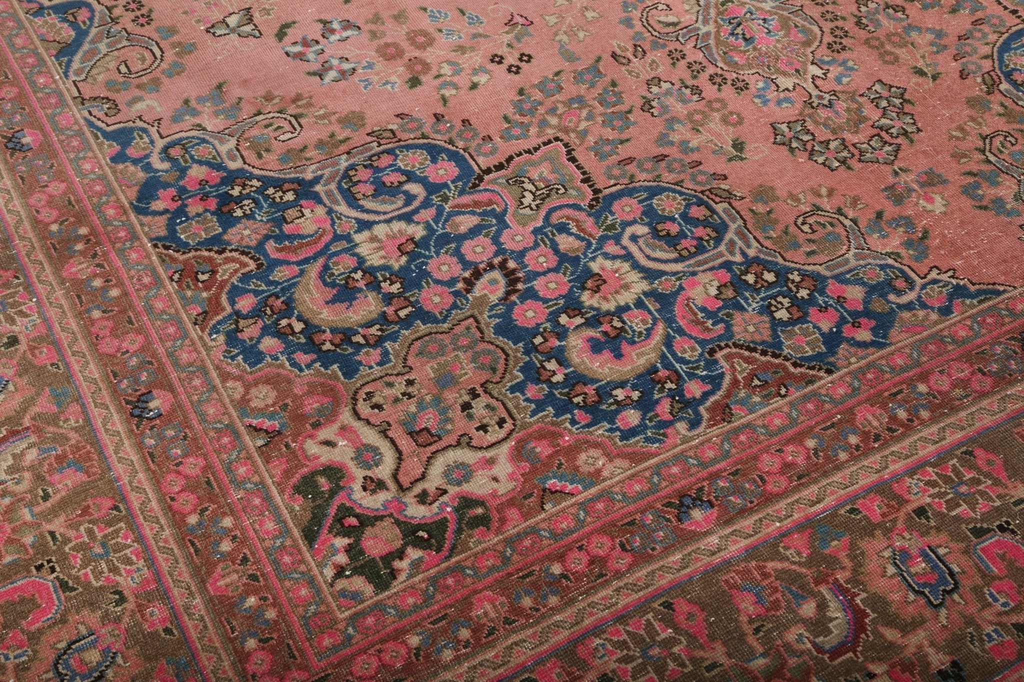 Persian Sabzevar rug floral motifs with vine-like border, dusty rose, teal, and navy