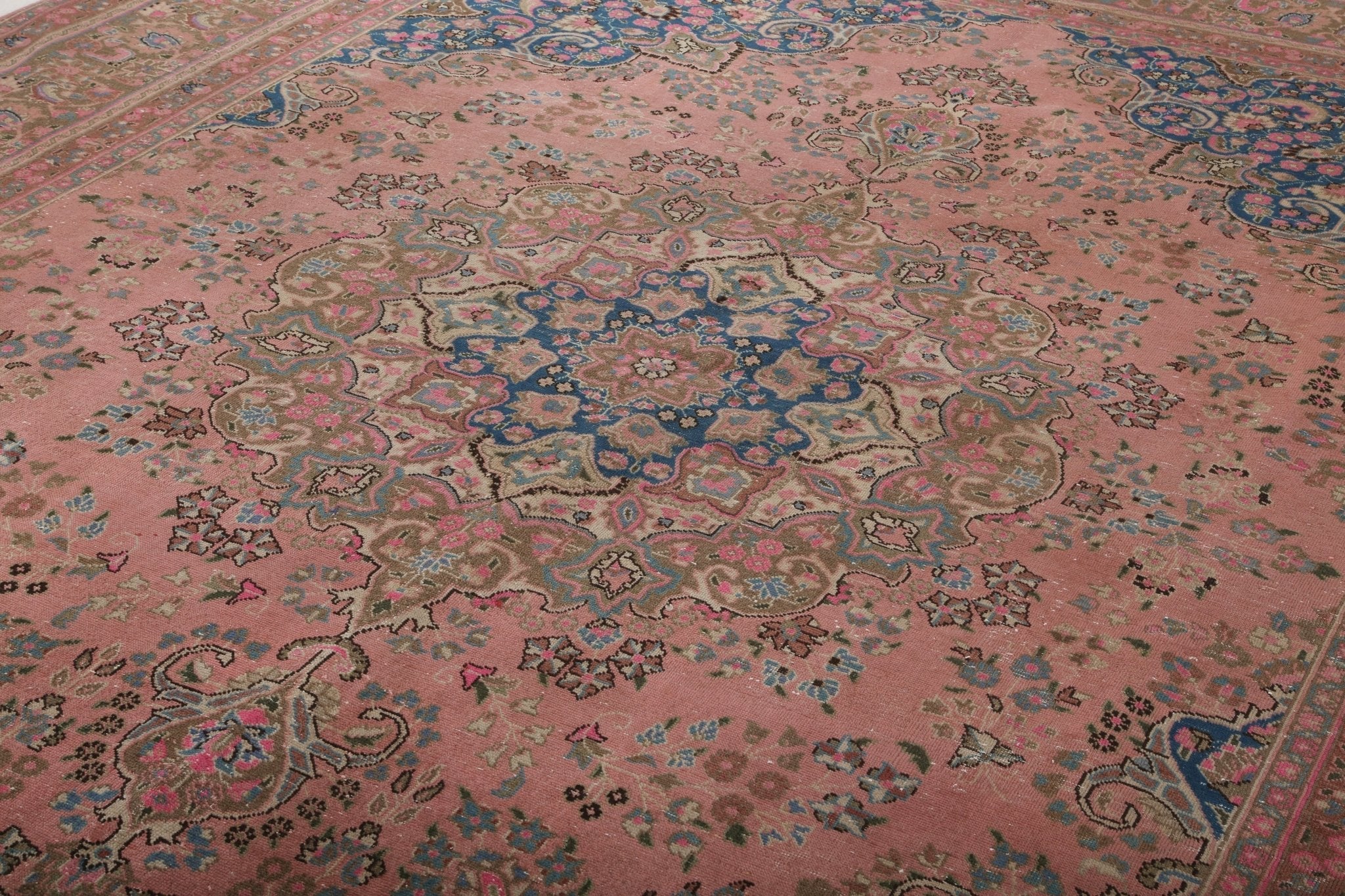 Large rose rug pattern with scrolling blue ornament and red frame border