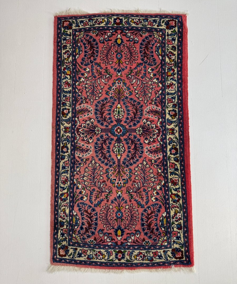 Persian Sarouk rug with red center medallion and navy border, multicolor pattern
