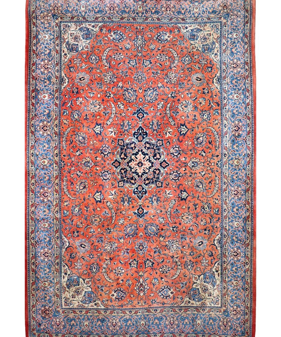 Persian Sarouk rug flat lay with red medallion field, blue border, floral lattice