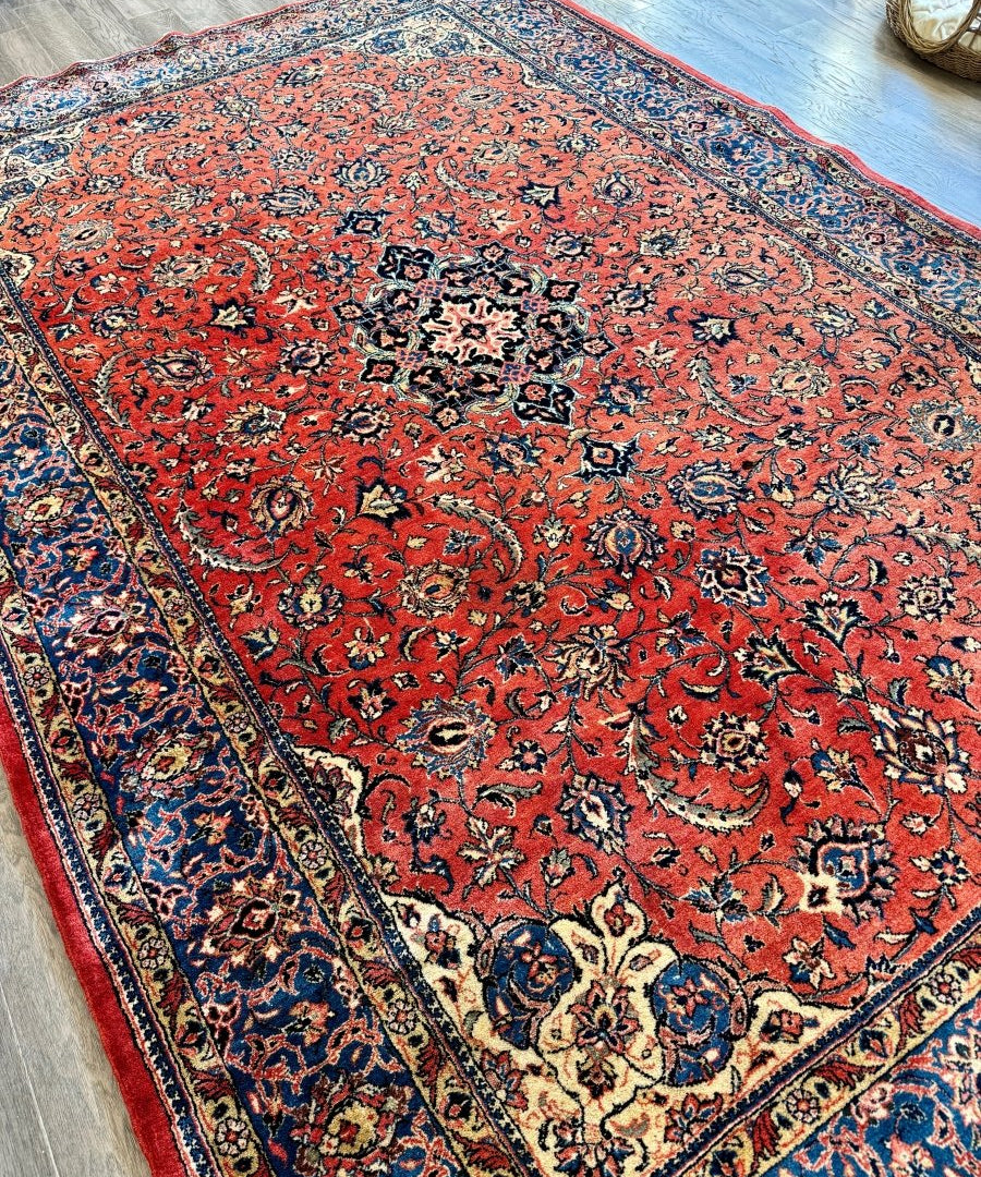 Persian Sarouk rug, red with dense blue ornamental motifs and dark border