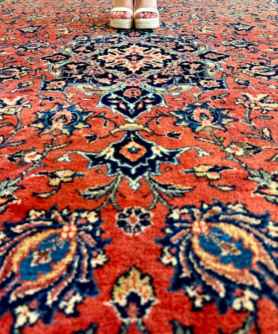 Persian Sarouk rug close-up with red field, blue accents, and cream highlights