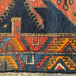 Persian runner rug decorative band with orange, navy, and yellow triangle and arrow motifs
