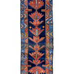 Navy and rust Persian-style runner rug with geometric medallion and border details