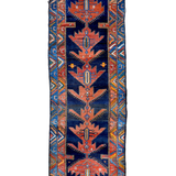 Navy and rust Persian-style runner rug with geometric medallion and border details