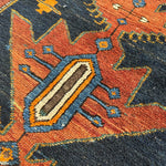 Geometric Persian runner rug motif in orange, teal, and navy with cream-lined shapes