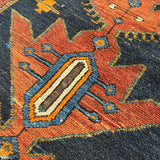 Geometric Persian runner rug motif in orange, teal, and navy with cream-lined shapes