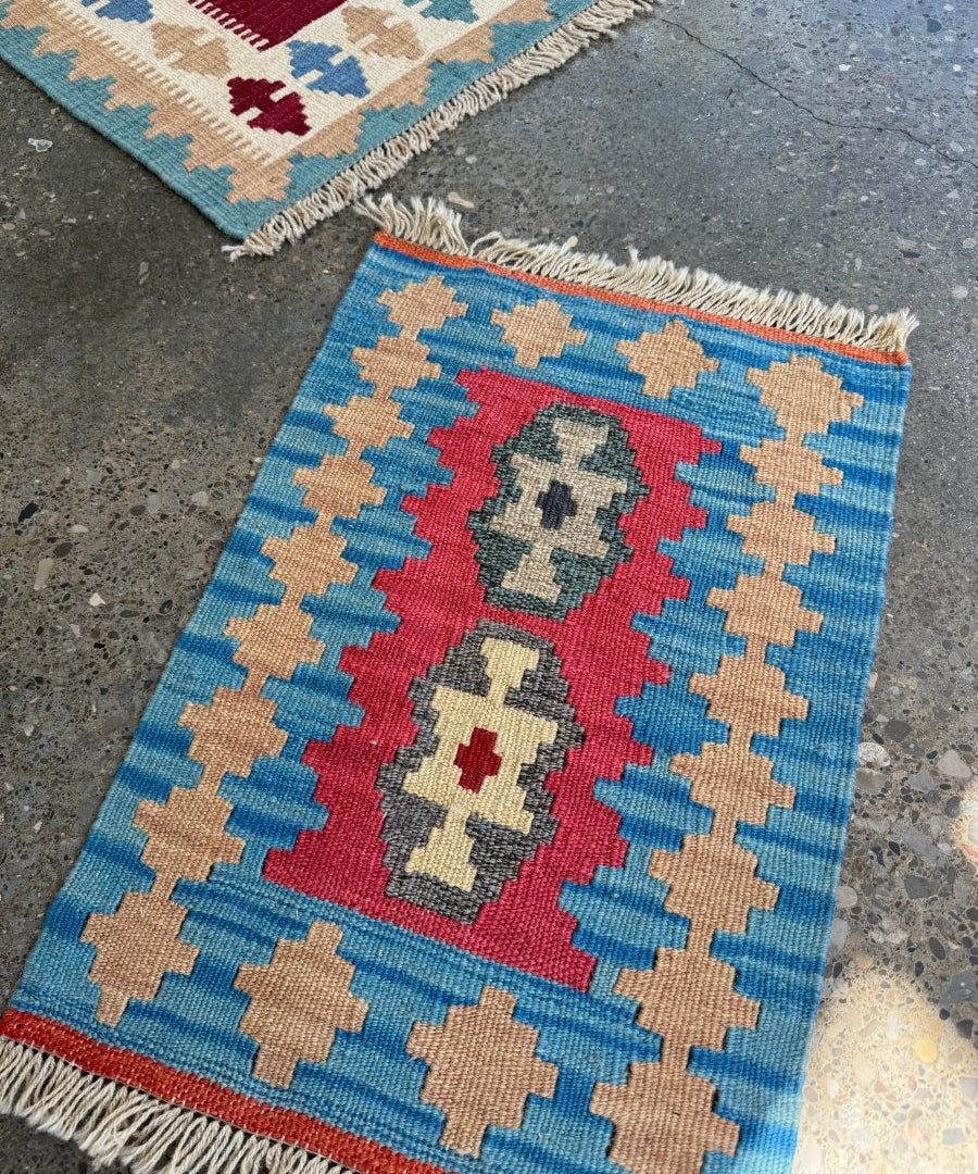 Persian Shiraz kilim rug, blue with red center, tan cross pattern and fringed edges