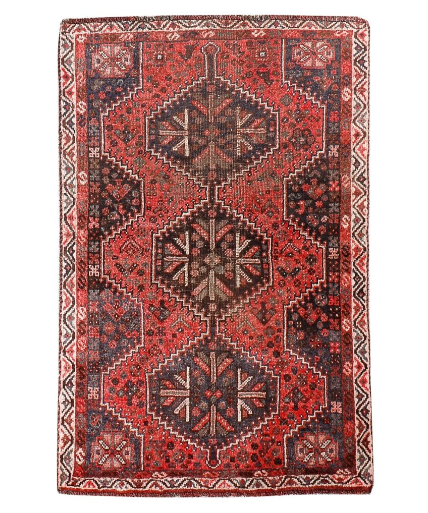 Persian Shiraz rug with red and dark geometric medallion pattern and cream border