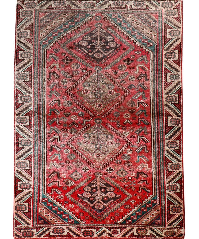 Persian Shiraz rug with red field and central medallion, teal and cream geometric pattern.