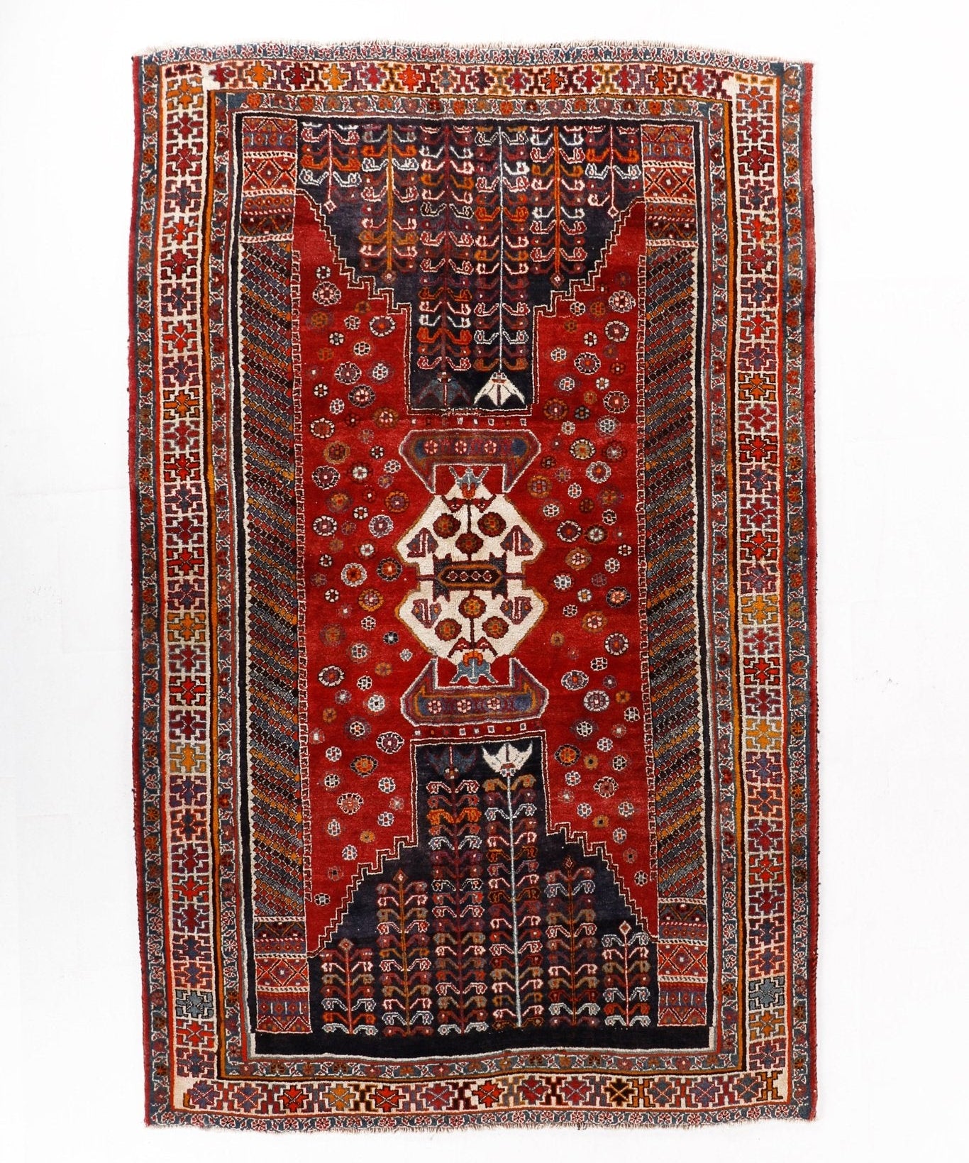 Persian-style red rug with dark medallion panel and ornate rectangular border