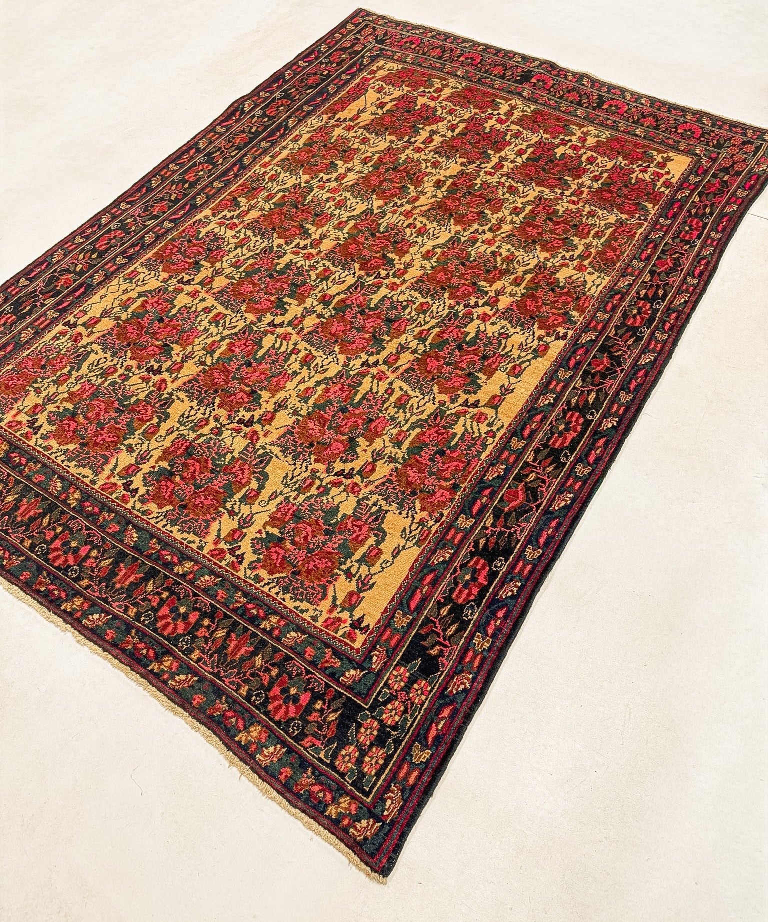 Persian Sirjan rug, floral medallion design in red, gold, and navy trim
