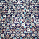 Persian Tabriz rug close-up with repeating small diamond and floral motifs