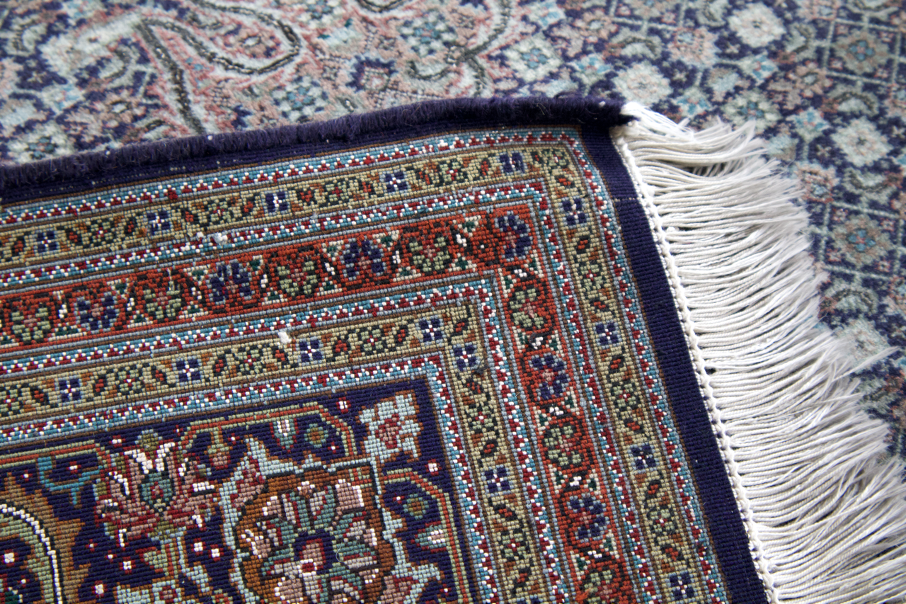 Persian Tabriz rug folded edge with white fringes and multicolor geometric border