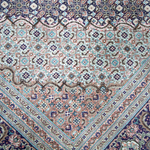 Persian Tabriz rug center medallion in pastel pink, teal, and navy
