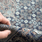 Persian Tabriz rug corner detail with hand pressing textured pile