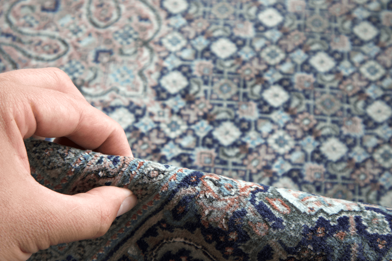 Persian Tabriz rug corner detail with hand pressing textured pile