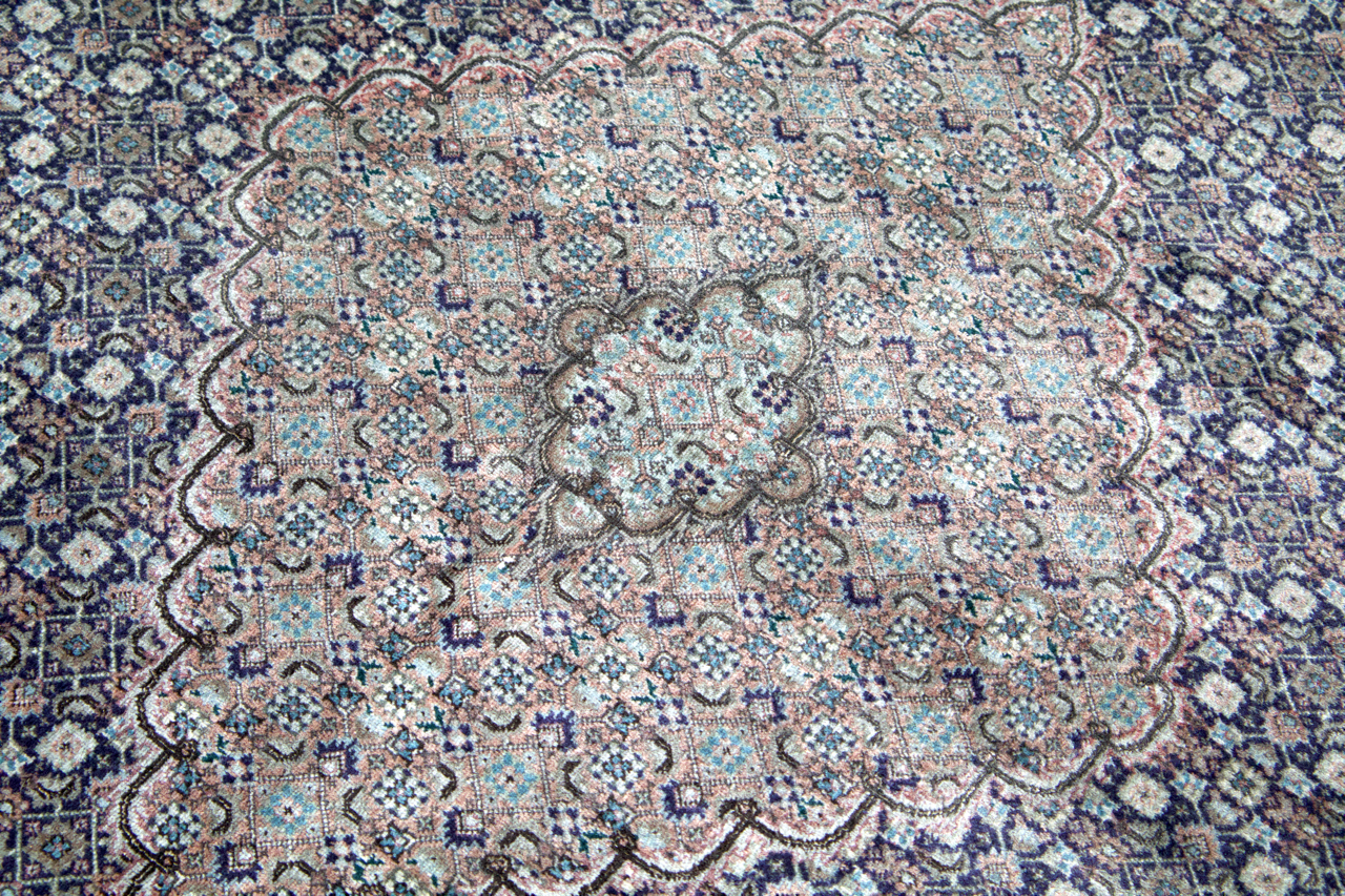 Persian Tabriz rug with central medallion and dense floral geometric field