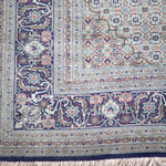 Persian Tabriz rug border with intricate swirls and short white fringe along edge