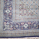 Persian Tabriz rug border with intricate swirls and short white fringe along edge